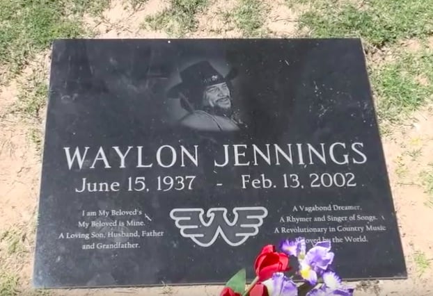 A photo of Waylon Jennings' grave marker, which contains lyrics from his favorite song "Belle of the Ball," according to his son Shooter