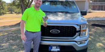 Austin Clagett poses with his hole-in-one ball and the truck he thought he won.