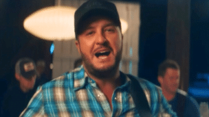 Luke Bryan in his music video for "But I've Got a Beer in My Hand"