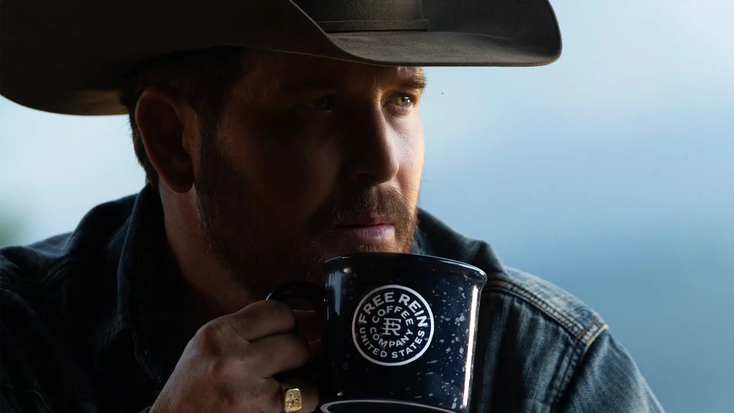 Cole Hauser poses with coffee cup for this new coffee company brand, Free Reain Coffee.