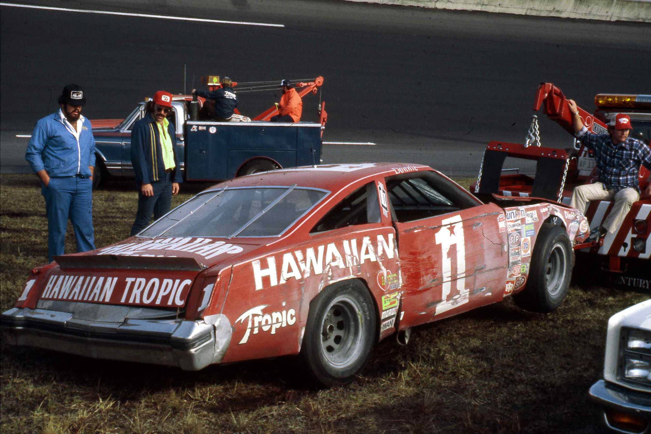 Donnie Allison’s wrecked Oldsmobile had to be pulled out of the Daytona infield by a wrecker. Photo courtesy of NASCAR Archives & Research Center via Getty Images