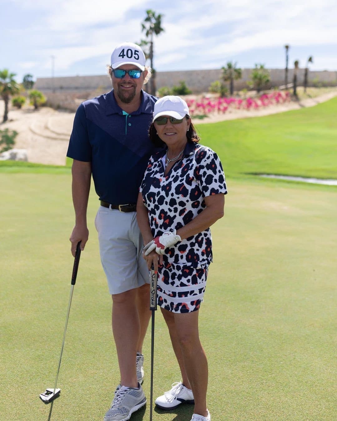 Toby Keith and wife playing golf.