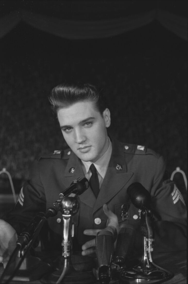 Elvis Presley speaks at a press conference while in the Army