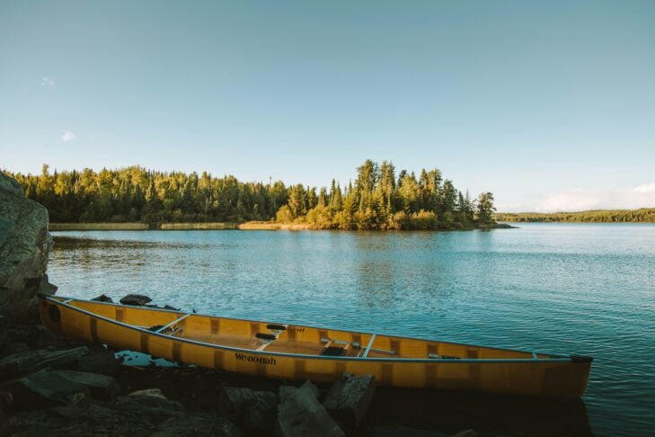 yellow canoe by a lake 