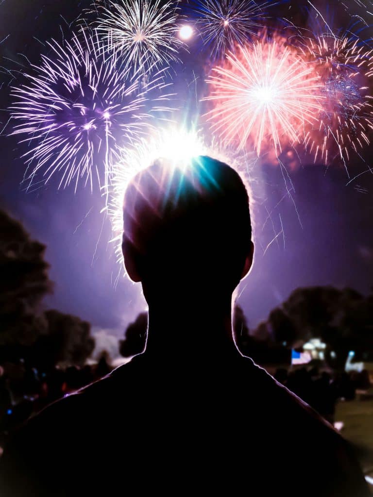 A person watches fireworks on the 4th of July
