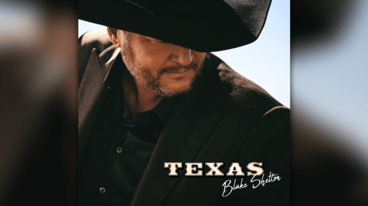 Blake Shelton in cowboy hat looking down