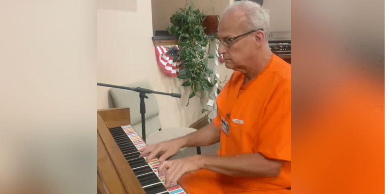 Anthony Yandell plays piano during prison Veteran's Day program