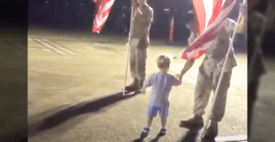 Two-year-old child shaking a veteran's hand