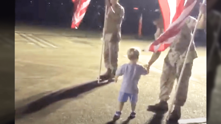 Two-year-old child shaking a veteran's hand