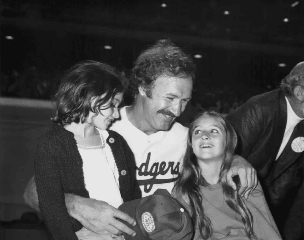 Gene, Elizabeth, and Leslie Hackman attend a celebrity baseball game