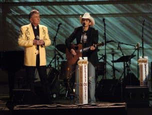 Brad Paisley playing the guitar alongside Bill Anderson