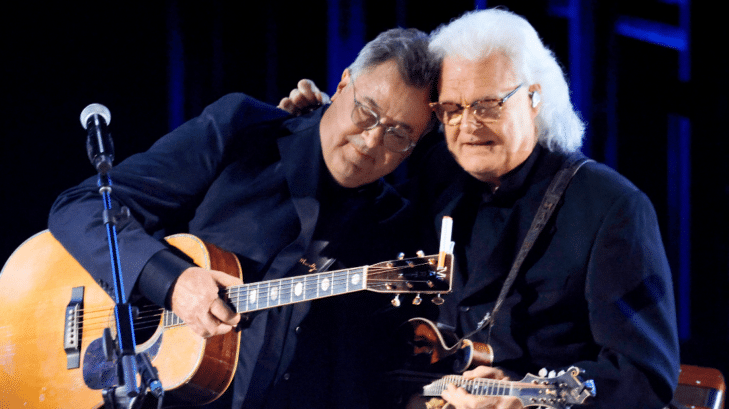 Ricky Skaggs embraces Vince Gill after singing with him on the "opry 100" tv special.