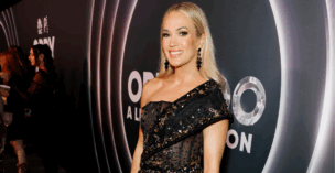 Carrie underwood in black dress at the Opry 100 celebration.