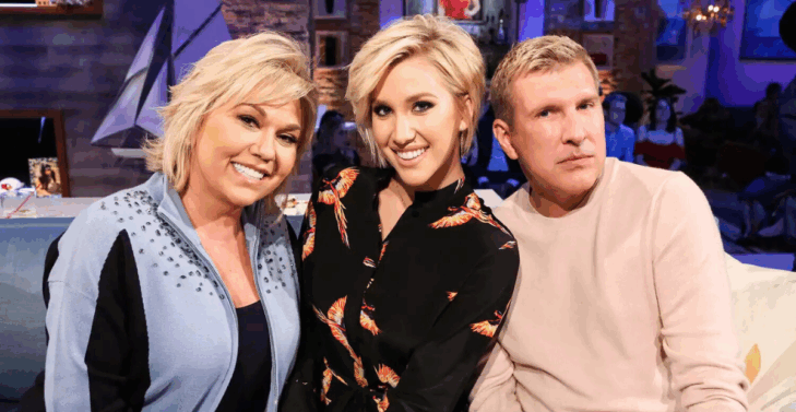 Julie and Todd Chrisley pose with their daughter, Savannah, center.