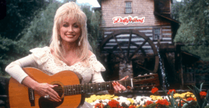 Dolly Parton poses for a portrait with her guitar at Dollywood circa 1993 in Pigeon Forge
