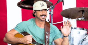 Sporting a mustache, Riley Green is pictured here in June of 2024.