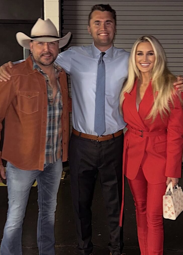 Jason and Brittany Aldean posing with Charlie Kirk