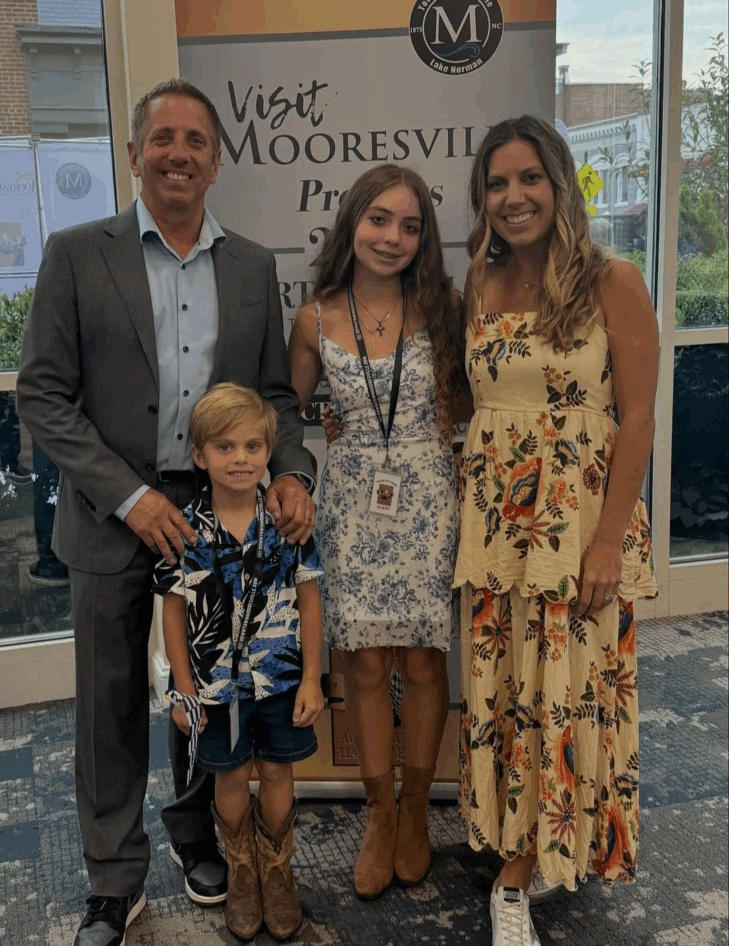 Greg Biffie posing with his son Ryder, daughter Emma, and wife Cristina