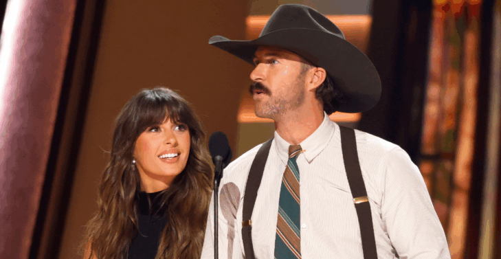 Riley Green and Ella Langley accept a trophy at the 2025 CMA Awards